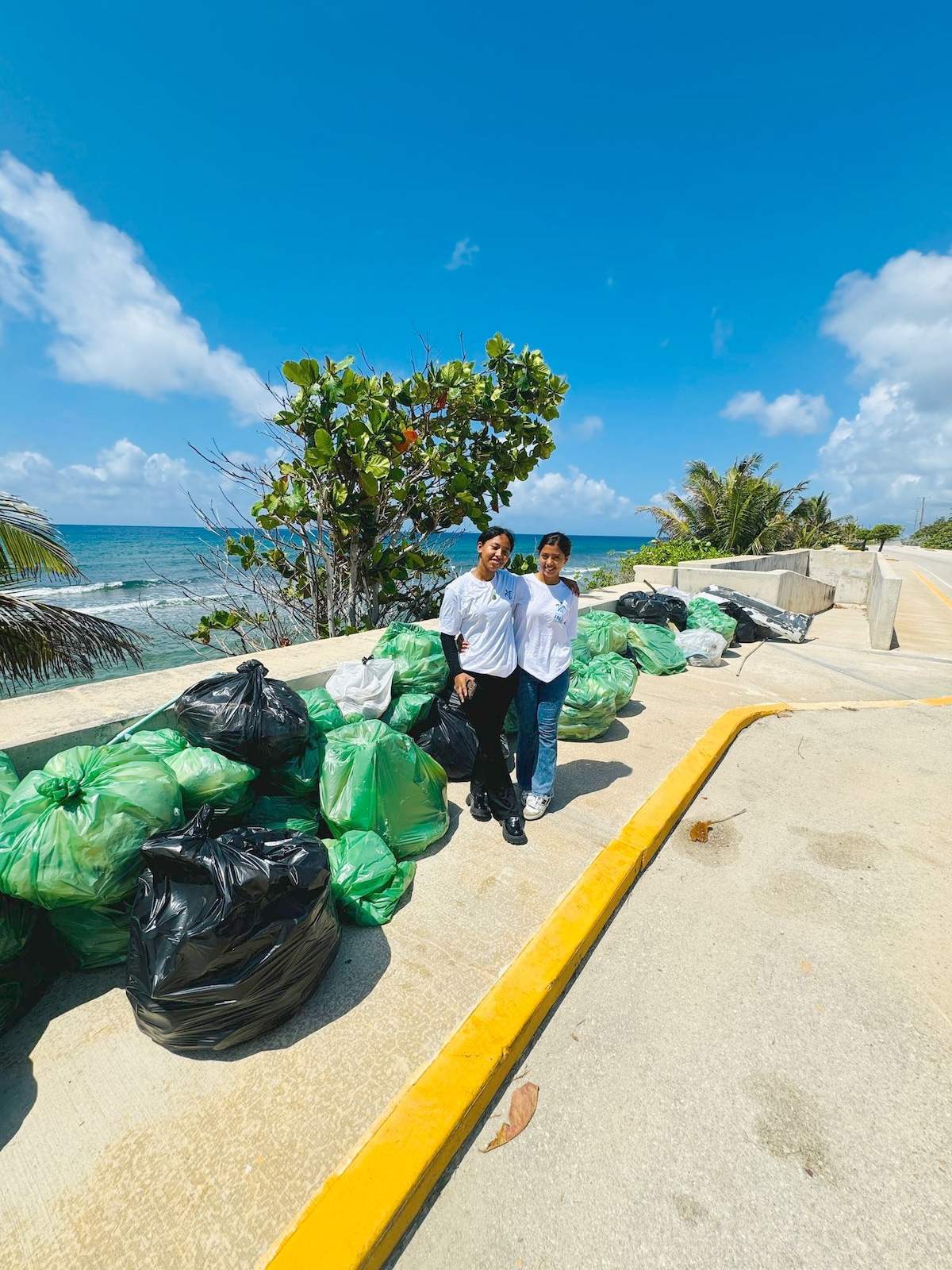 Complete Clean Team Helping Remove Coastal Litter During Earth Day Cleanup at East End Beach, Cayman Islands