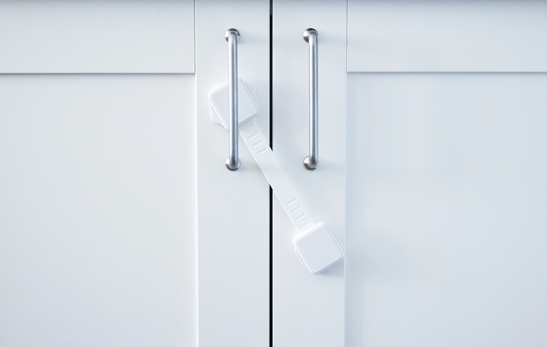 Childproof cabinet with safety latch for secure storage of cleaning supplies—an essential practice in homes with young children.